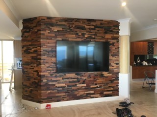 Clad wall facade with large Wall Mounted TV by Jim's Antennas