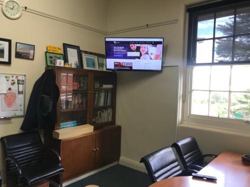 Office with Wall Mounted TV highset in corner by Jim's Antennas